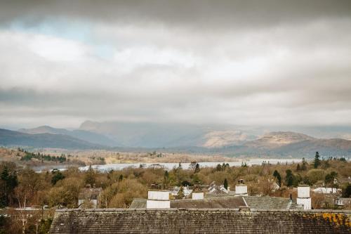 a view of a town with a river and mountains at Heathmere- lovely views, free parking, pet friendly in Windermere