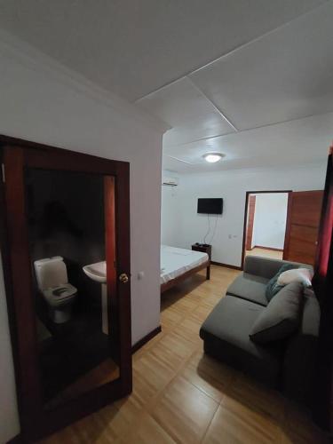 a living room with a couch and a bed at Green Hill Lodge in Lopes