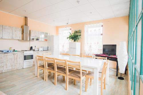 cocina y comedor con mesa blanca y sillas en Maria Hostel, en Valga