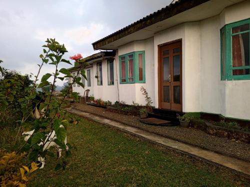 a row of houses with green and white at Mount View Cottage in Nuwara Eliya