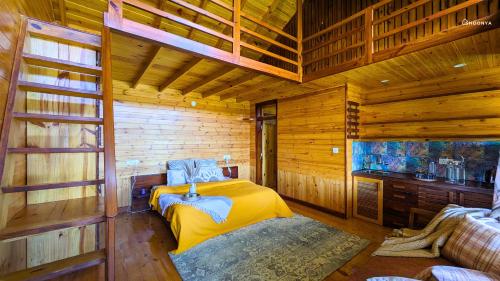 a bedroom with a bed in a wooden cabin at Shoonya x Aranya Agosh - Letibunga Mukteshwar in Mukteswar