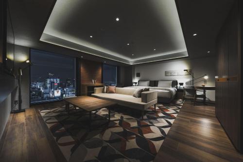 a living room with a couch and a table at SAPPORO STREAM HOTEL in Sapporo