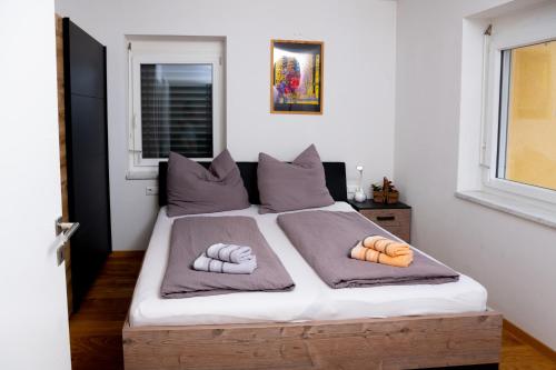 a bedroom with a bed with two pillows on it at Ferienhaus Seeblick in Drobollach am Faakersee