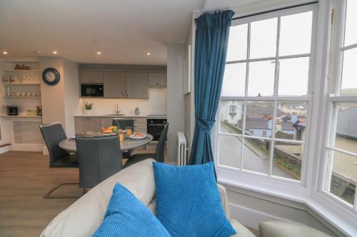 a living room with a couch and a large window at Queens View in Dartmouth