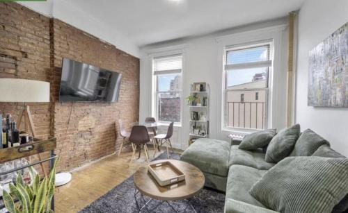 a living room with a couch and a brick wall at Apartment near Union Square in New York