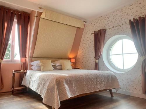 a bedroom with a bed and a large window at Brigitte et Moi in Chancelade