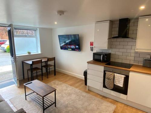 a kitchen with a counter and a table and a counter top at LT Apartments 56 - Free St parking in Leicester