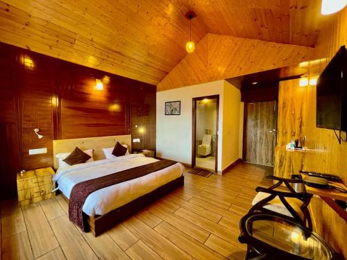 a bedroom with a large bed in a room at SYLVAN RESORTS - Mountain View in Solan