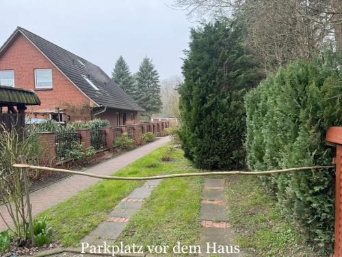 a yard with a hose attached to a house at Ferienwohnung Schröder in Putbus