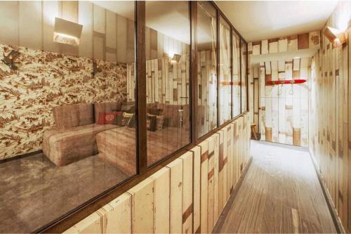 a large room with a couch and some windows at Chalet Ilulissat in Courchevel