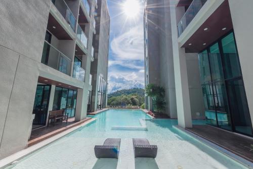 a swimming pool in the middle of a building at Duplex Pool Access 2brs Patong in Patong Beach