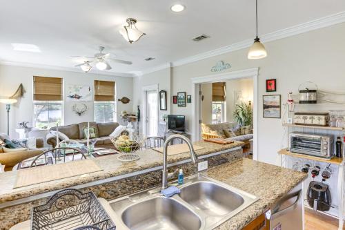 a kitchen with a sink and a living room at Lovely Carrabelle Home with Lake Views and Pool Access in Carrabelle