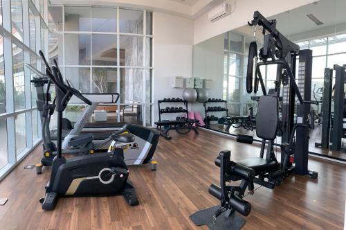a gym with treadmills and exercise equipment in a room at Two Bedroom Apartment at The Nove, Nuvasa Bay, Nongsa 719 in Nongsa