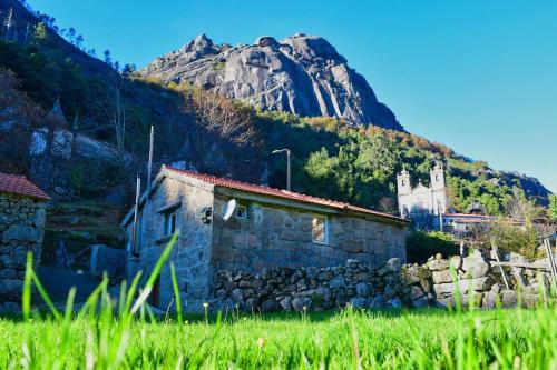 a stone building in front of a mountain at Casa Ti' Beites, no Santuário de Nossa Senhora da Peneda in Arcos de Valdevez
