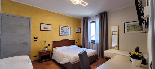 Postel nebo postele na pokoji v ubytování Agriturismo Le Arcate