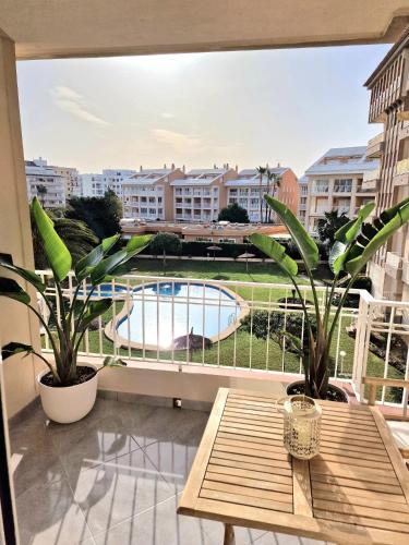 a balcony with a table and a view of a pool at Arenal in Jávea