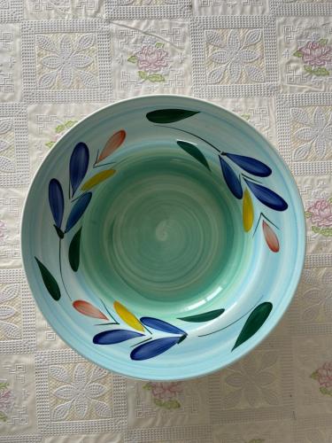 a green bowl sitting on top of a table at La Romantica in Riccione