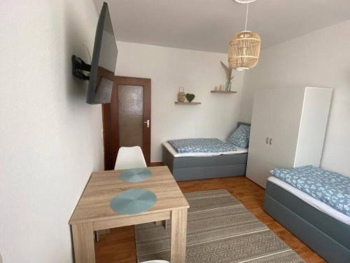 a living room with a table and two beds at gemütliches Apartment in Marl - WG 1 in Marl
