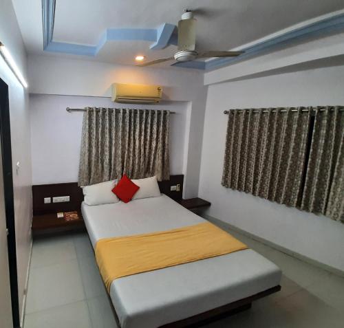 a bedroom with a bed and a ceiling at hotel royal night in Ahmedabad