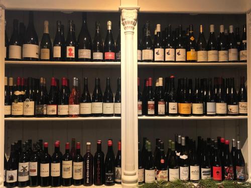 a shelf filled with lots of bottles of wine at B&B Vigne Vierge in Aigne