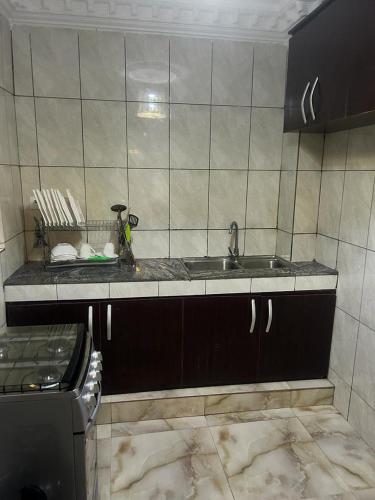 uma cozinha com um lavatório e uma bancada em CHAMBRE em Douala