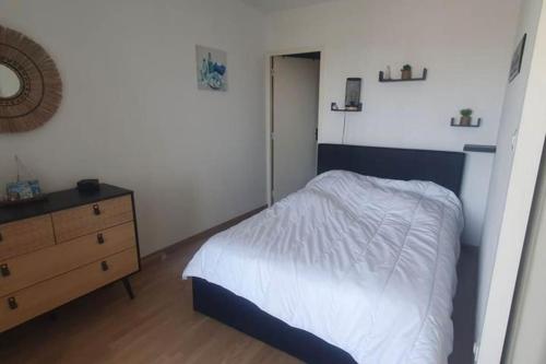 1 dormitorio con 1 cama, vestidor y puerta en Appartement front de mer - 6198, en Soulac-sur-Mer