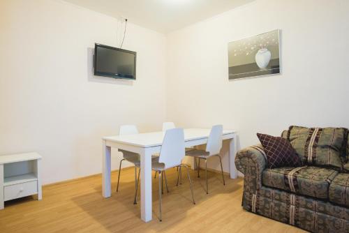 a living room with a table and chairs and a couch at Maria Hostel in Valga