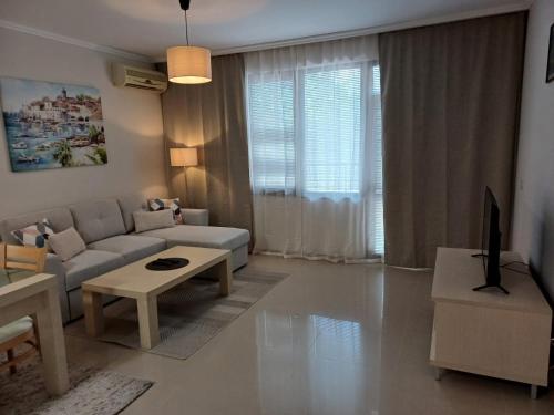 a living room with a couch and a table at Lighthouse 1bedroom GeC apartment 203 in Balchik