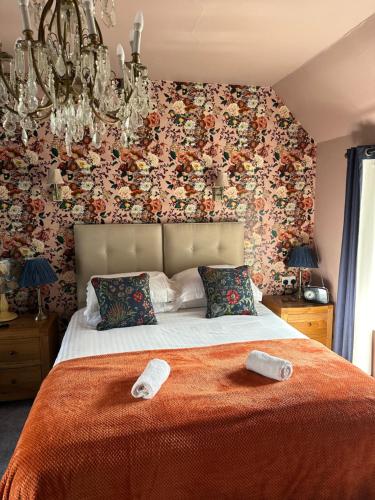 a bedroom with a bed with two towels on it at The Union Inn in Cowes