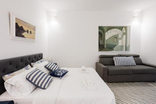 a bedroom with a large bed and a couch at MAISON SAINT MICHAEL in Capri