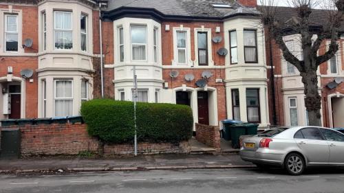 a silver car parked in front of a house at Cosmopolitan Comforts Flat in Coventry
