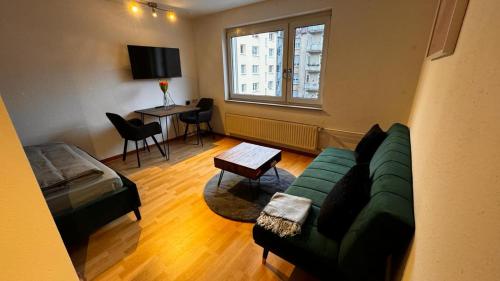a living room with a couch and a table at Apartment 24 im Lehenviertel in Stuttgart