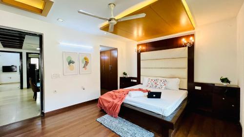 a bedroom with a bed and a ceiling fan at BluO 3BHK Green Park, Private Garden Lift - Balcony in New Delhi