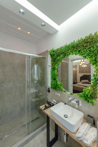 a bathroom with a sink and a shower and a mirror at Bed & Breakfast Il Narciso in Rome