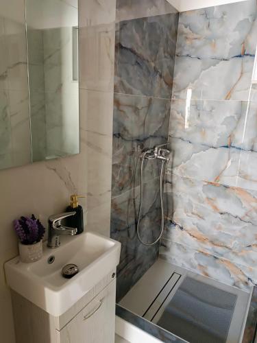 a bathroom with a sink and a shower at ARMIRA HOME in Kalymnos