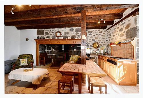 a kitchen with a table and a stove top oven at Maison confortable avec vue sur la montagne à Le Fau in Le Fau