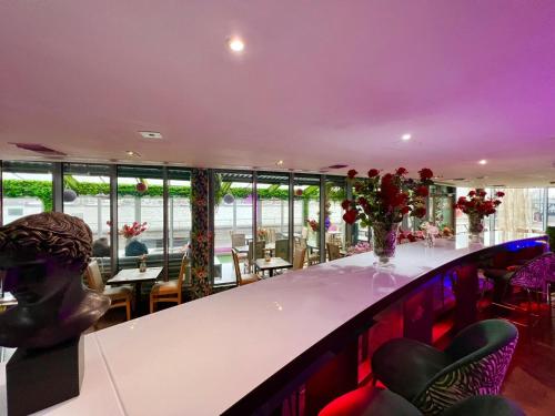 a bar in a restaurant with tables and chairs at Rafayel Hotel & Spa in London