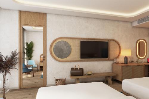 a bedroom with a tv on a wall at The Isolano, Cres, Autograph Collection in Cres