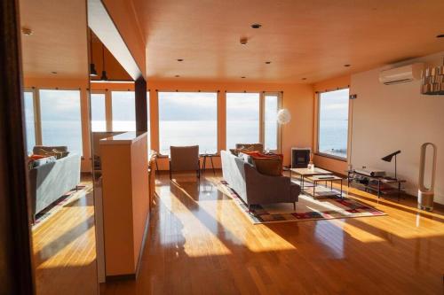 a large living room with a lot of windows at Nesaki Native in Hakodate
