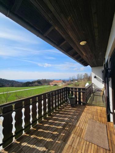 a porch of a house with a view of a field at d' Aussicht nach LA in Deggendorf