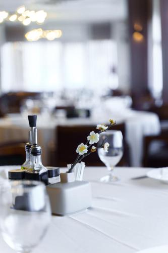 a table with a bottle of perfume and a wine glass at Hotel Montana SPA in Kruševo