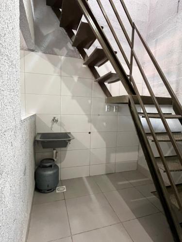 a bathroom with a sink and a staircase at Apartamento Loft in Rio Verde