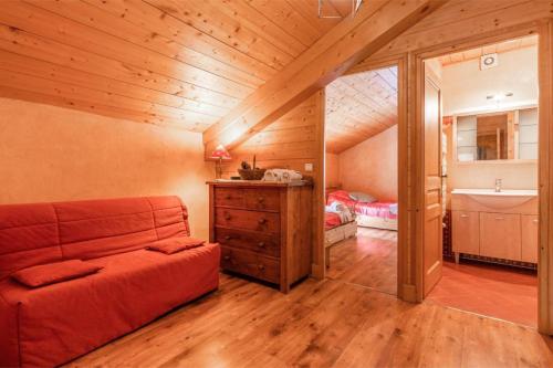 a room with a couch and a sink in a attic at Le Gîte des Cascades in Sixt