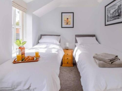 two beds in a room with a tray of food at Stunning 2-Bed House in Walkington near Beverley in Beverley