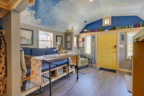 a room with a table and a yellow door at Blue Dream Cabin in Rising Fawn with Fire Pit! in Rising Fawn