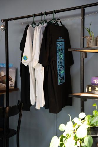 a closet with a rack with shirts on it at Villa Viva Cape Town in Cape Town