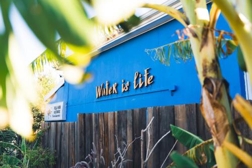 a blue house with a sign that reads wake is life at Villa Viva Cape Town in Cape Town