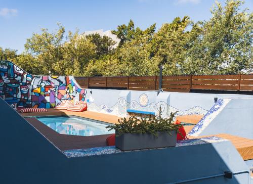 a swimming pool with a mural on the wall at Villa Viva Cape Town in Cape Town