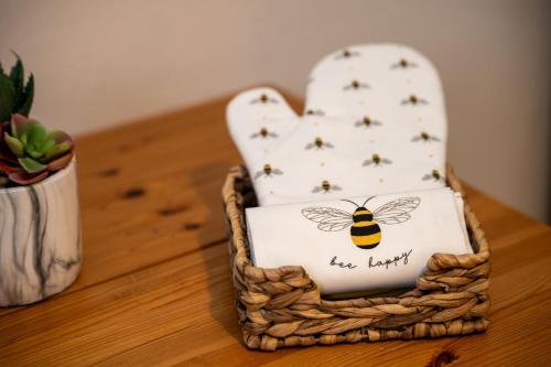 a basket with a bee sitting on top of a table at Cosmopolitan Comforts Flat in Coventry