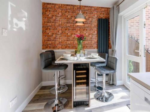a kitchen with a small table and two stools at Stunning 2-Bed House in Walkington near Beverley in Beverley